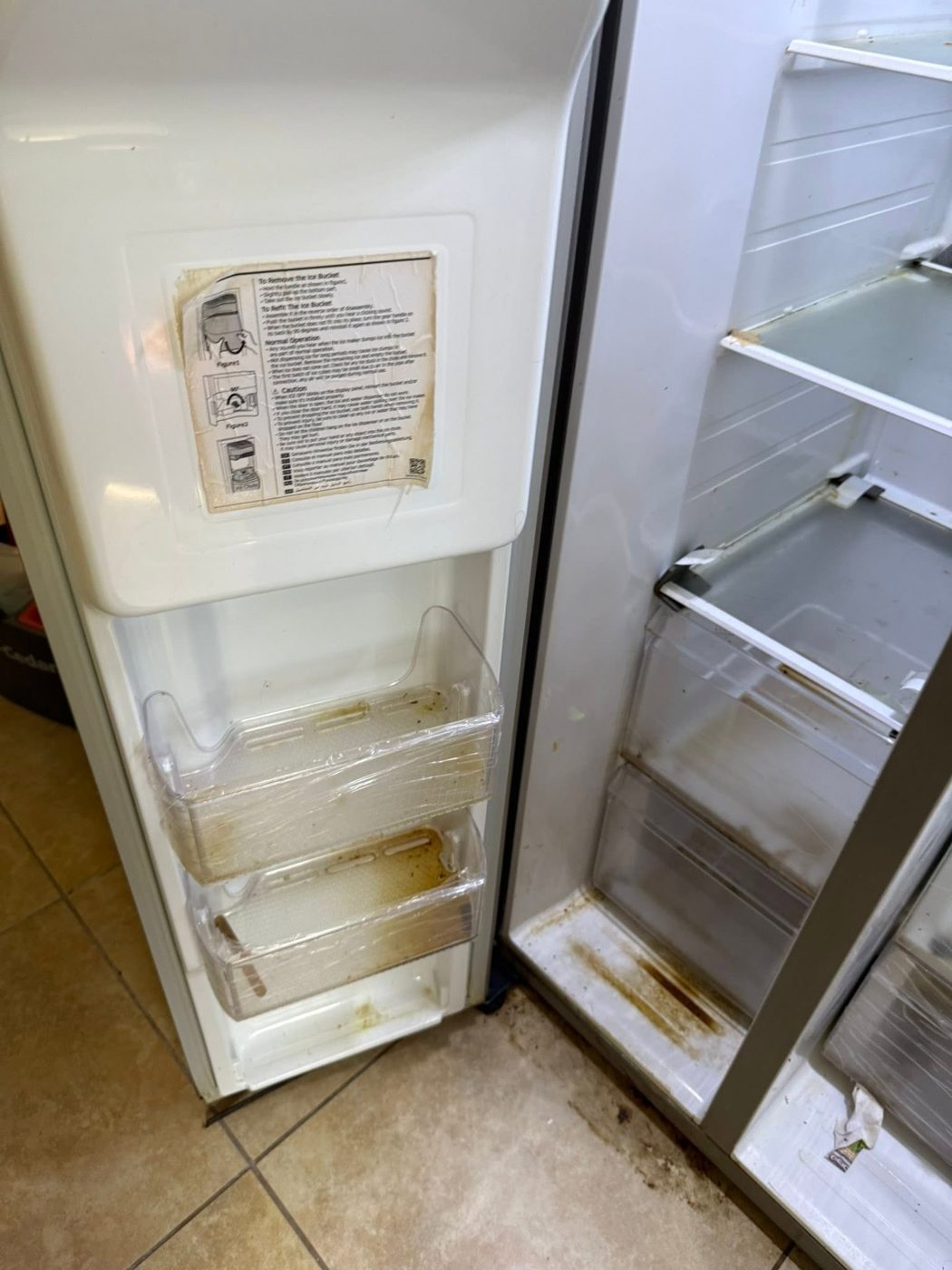 Refrigerator door bins before cleaning — sticky residue