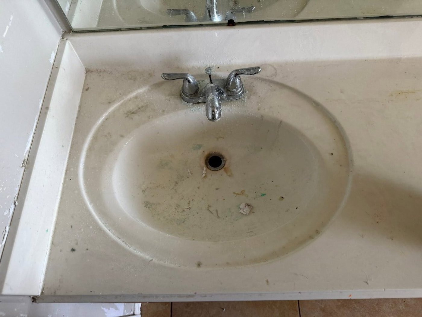 Bathroom sink before cleaning — stained and grimy